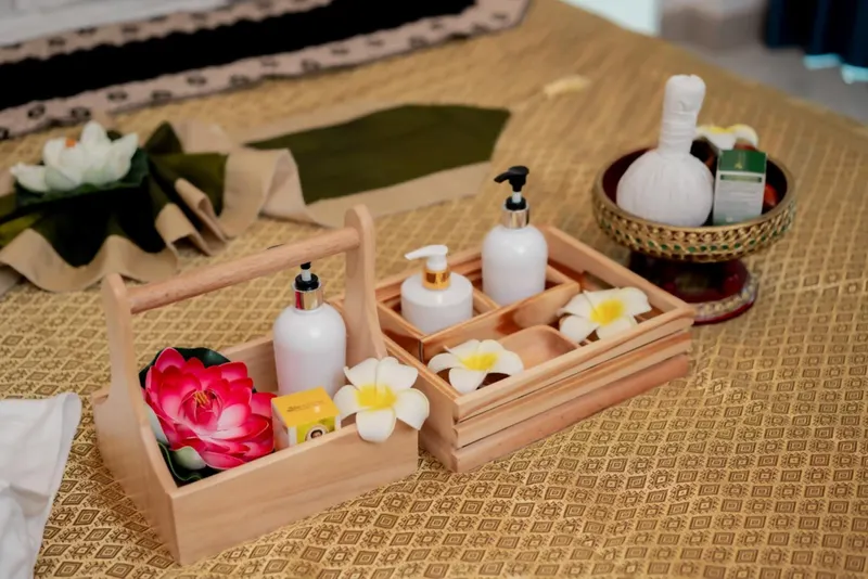 Massage oils and herbal compress ready for an outcall session